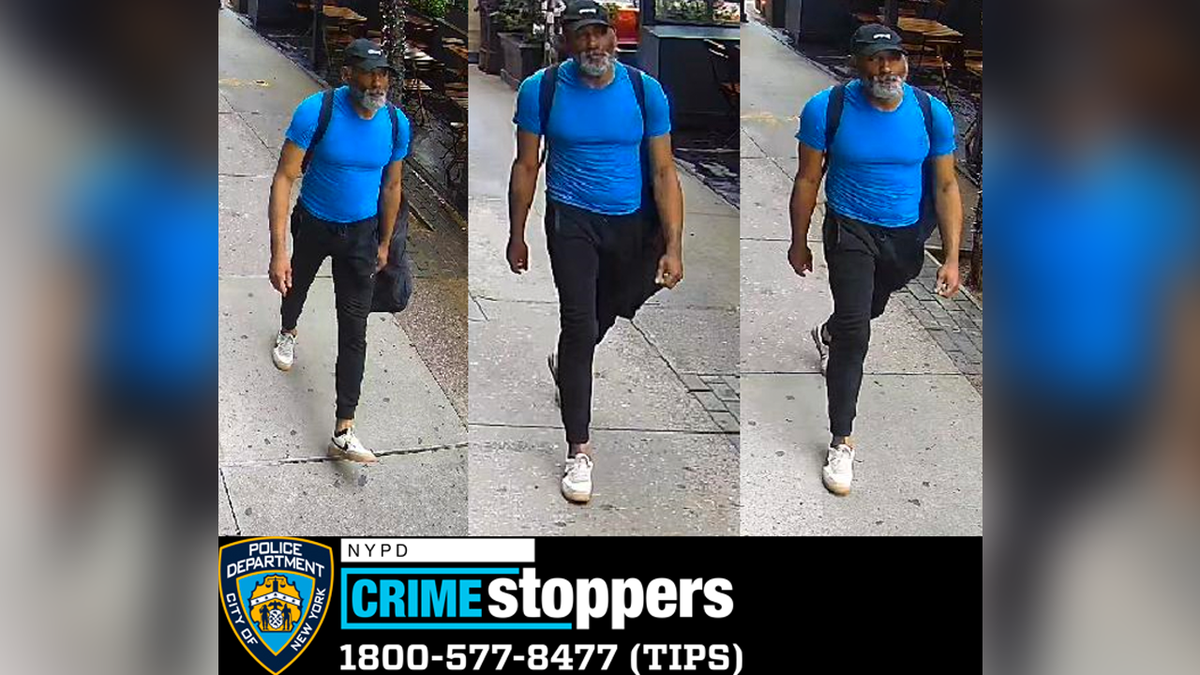 A photo from NYPD Crimsestoppers showing a man in a blue shirt and black pants walking
