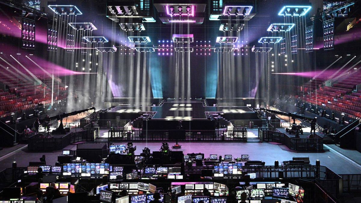 Pink and blue laser lights shine over the completed Eurovision stage at Malmo Arena.