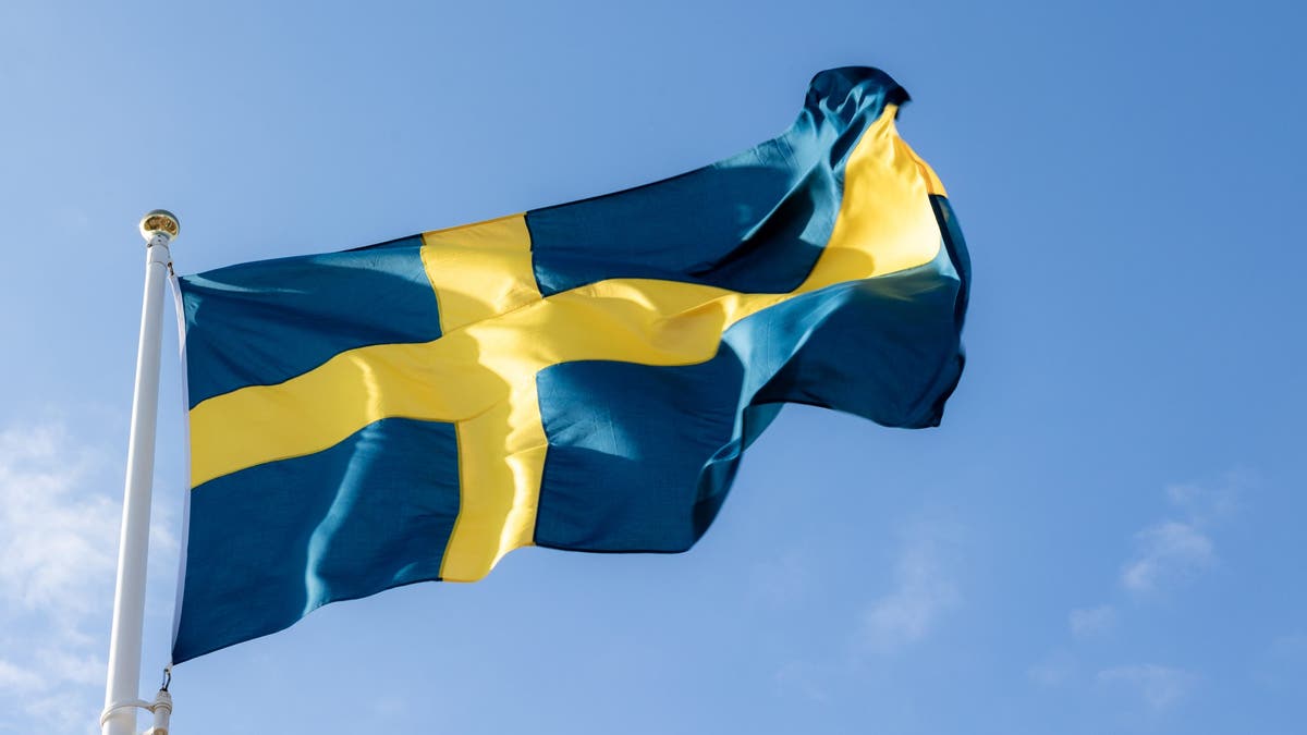 Swedish flag flying with a blue-sky background