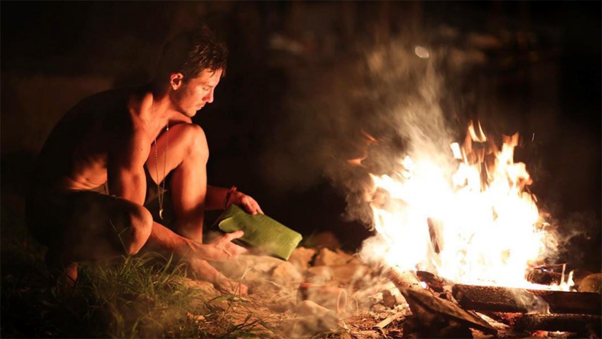 Justin Alexander Shetler tending to a fire
