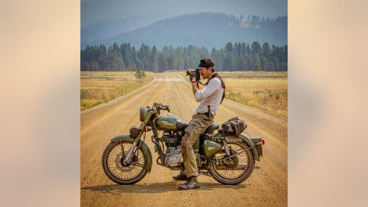 Justin Alexander Shetler taking a photo from his motorcycle