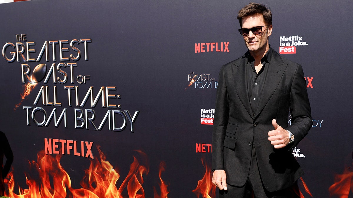 Tom Brady poses on the carpet