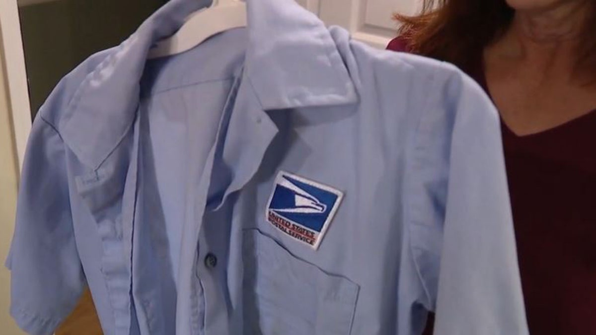 Postal worker showing her uniform