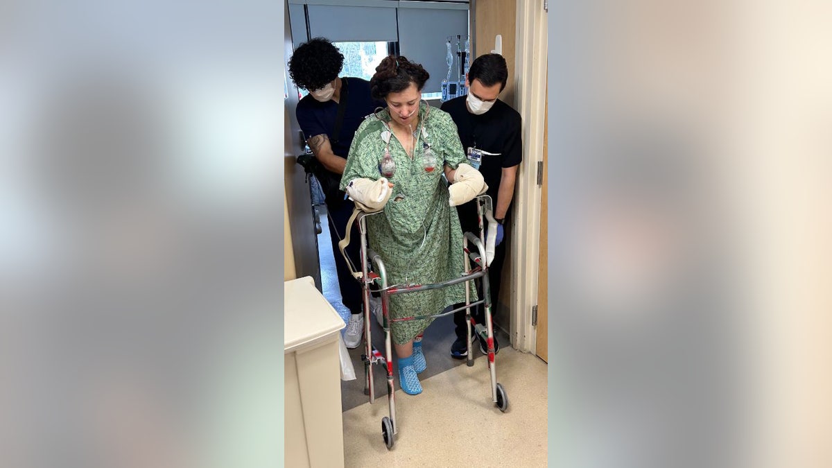 Allie Sheborn walking with walker at the hospital