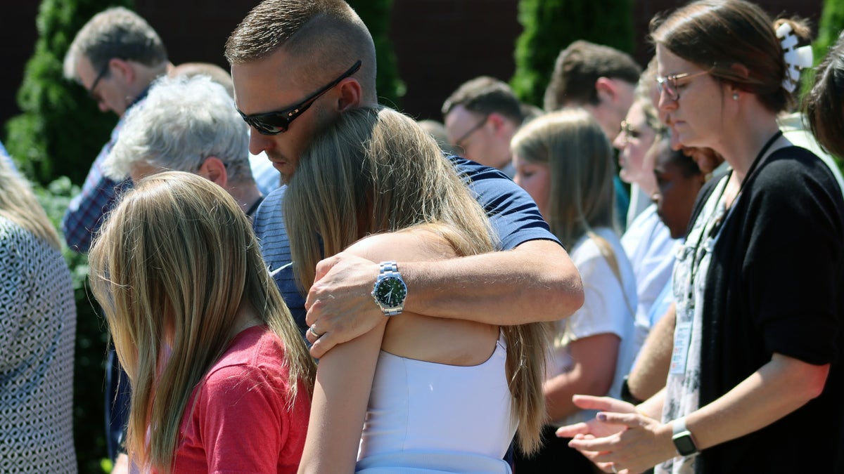 Community members at Asher Sullivan's prayer vigil hold each other, as they hope the 10-year-old pulls survives the insurmountable odds.