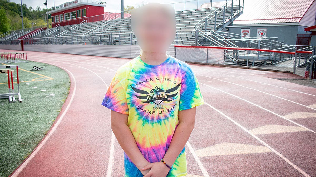 blurred-face photo of trans athlete Becky Pepper Jackson standing on track