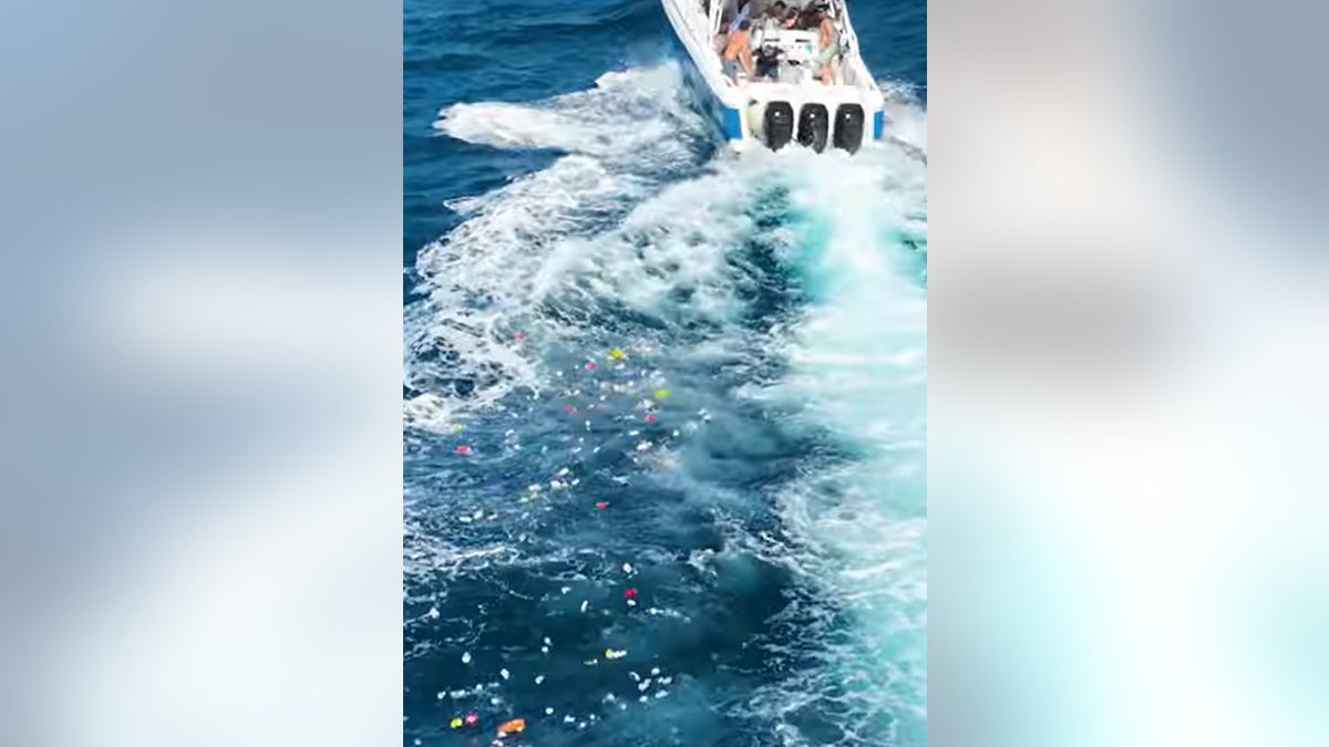 A trail of trash is behind the boat after Boca Bash partiers dumped bins of garbage in the Atlantic.