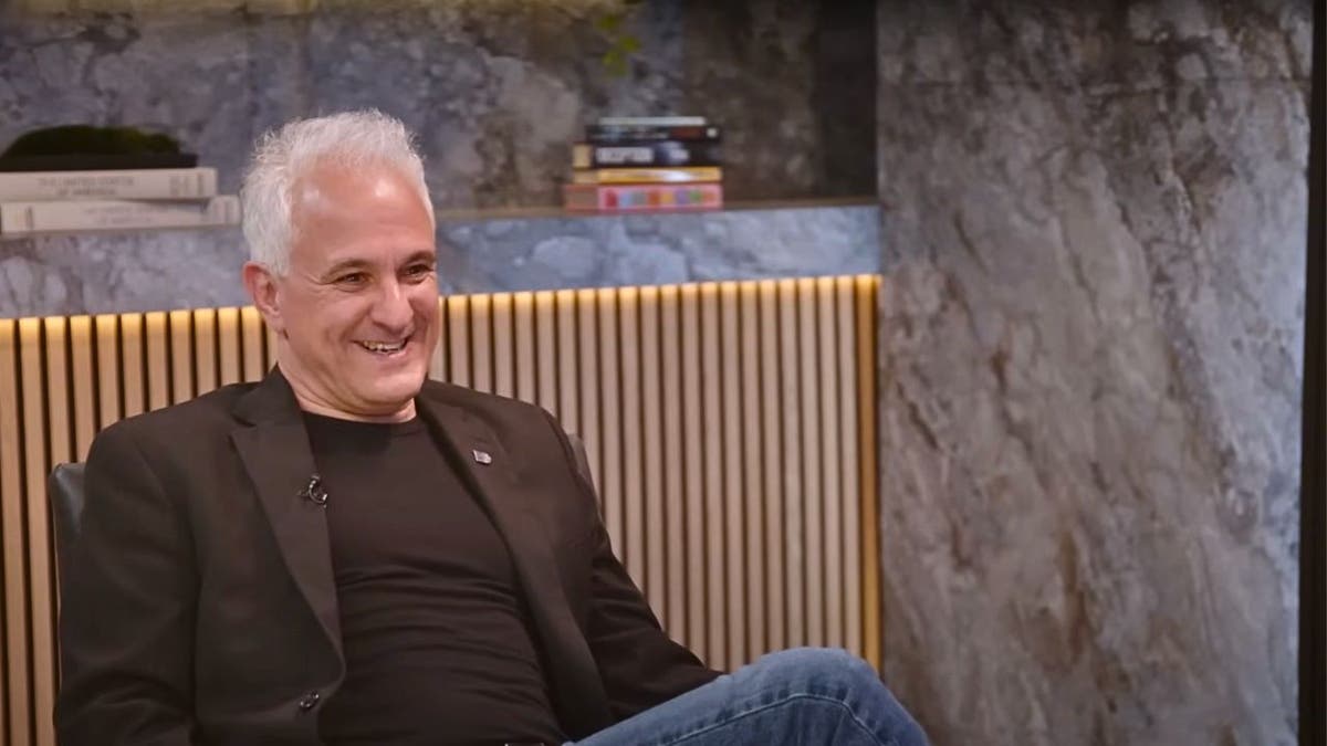 Photo of Peter Boghossian, man sitting on chair smiling
