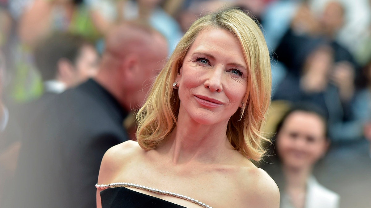 Cate Blanchett at the Cannes Film Festival in a black strapless dress soft smiles