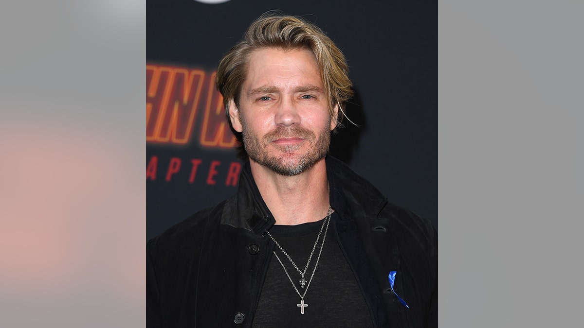 Chad Michael Murray in a black shirt and jacket looks serious on the carpet