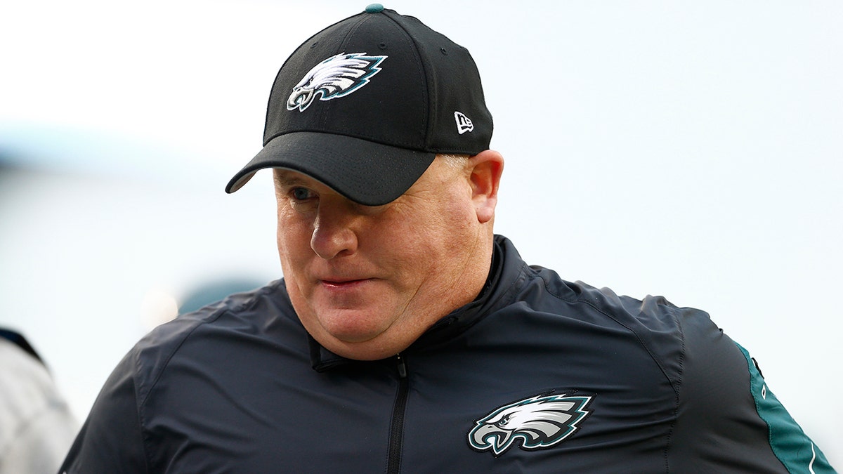 Chip Kelly on field with Eagles