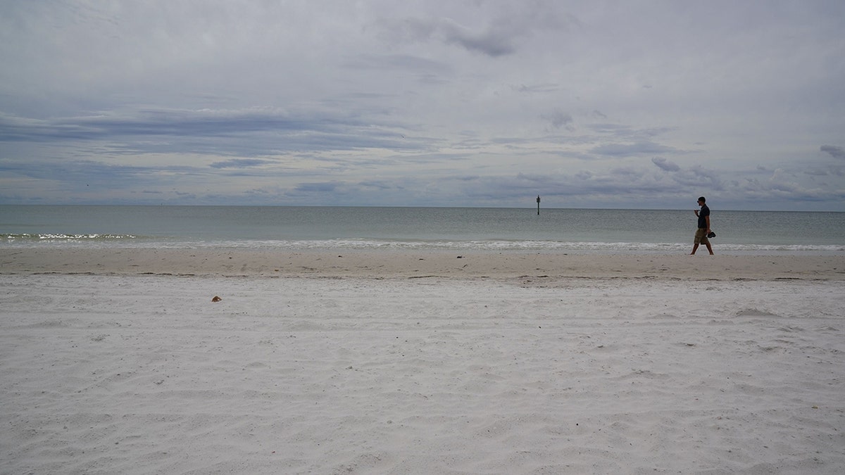 Person walking on sand at Clearwater Beach