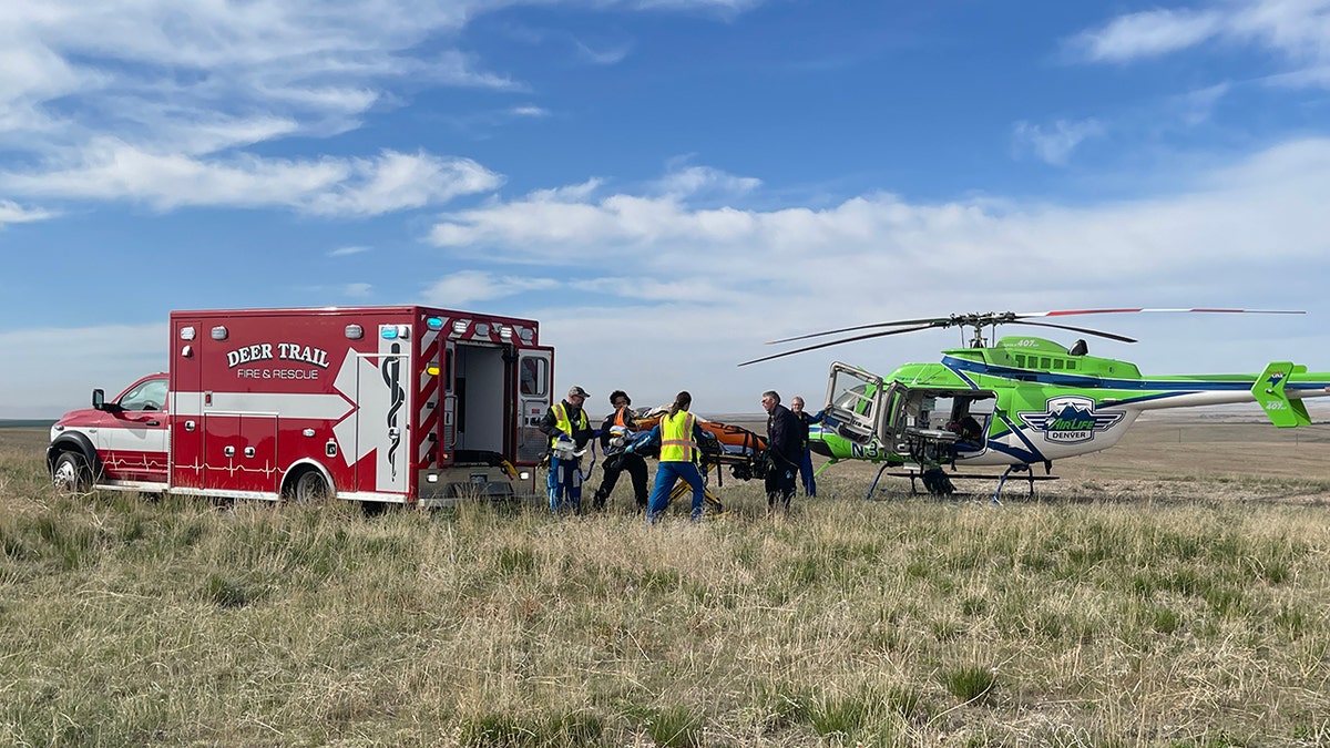 Rescued boy near ambulance, helicopter