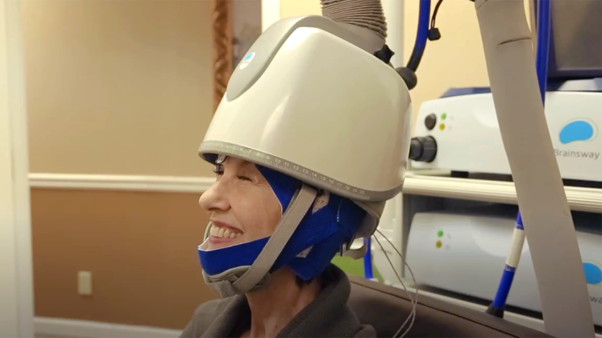 woman smiles while wearing deep tms helmet