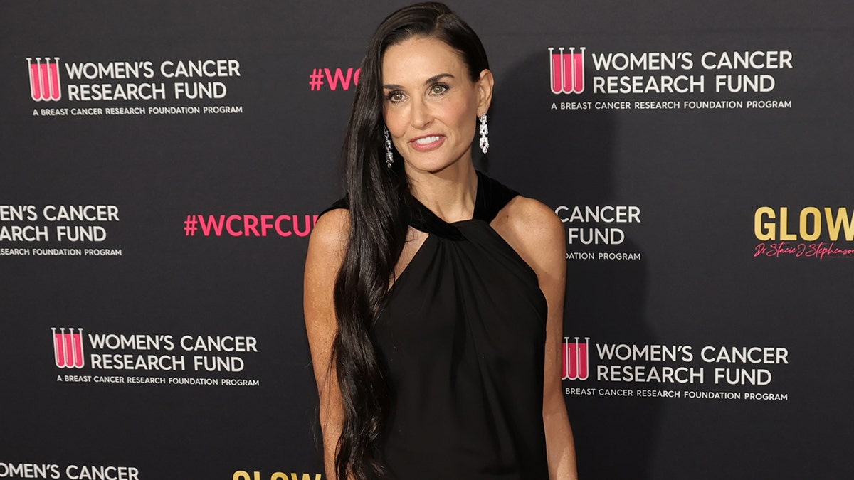 Demi Moore on the red carpet in a black dress