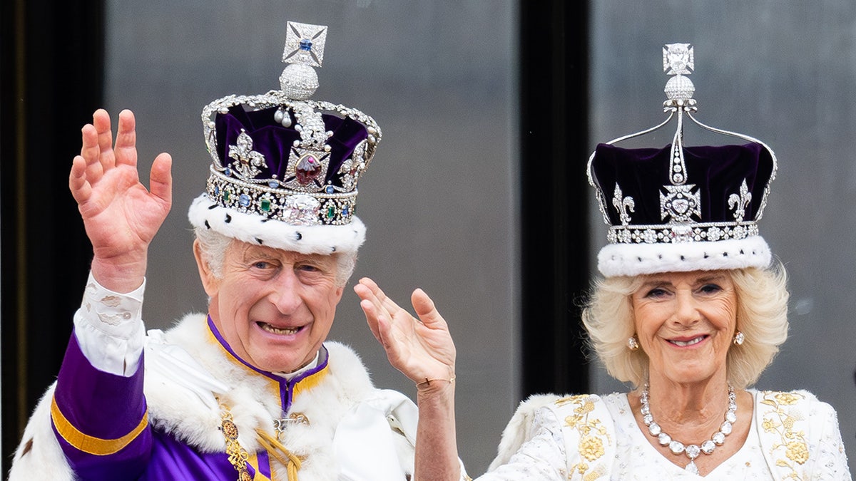 King Charles and Queen Camilla waving wearing their crowns