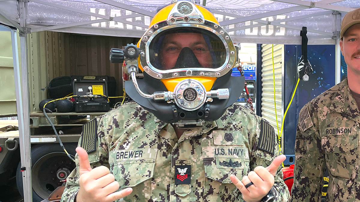 navy diver in a dive helmet