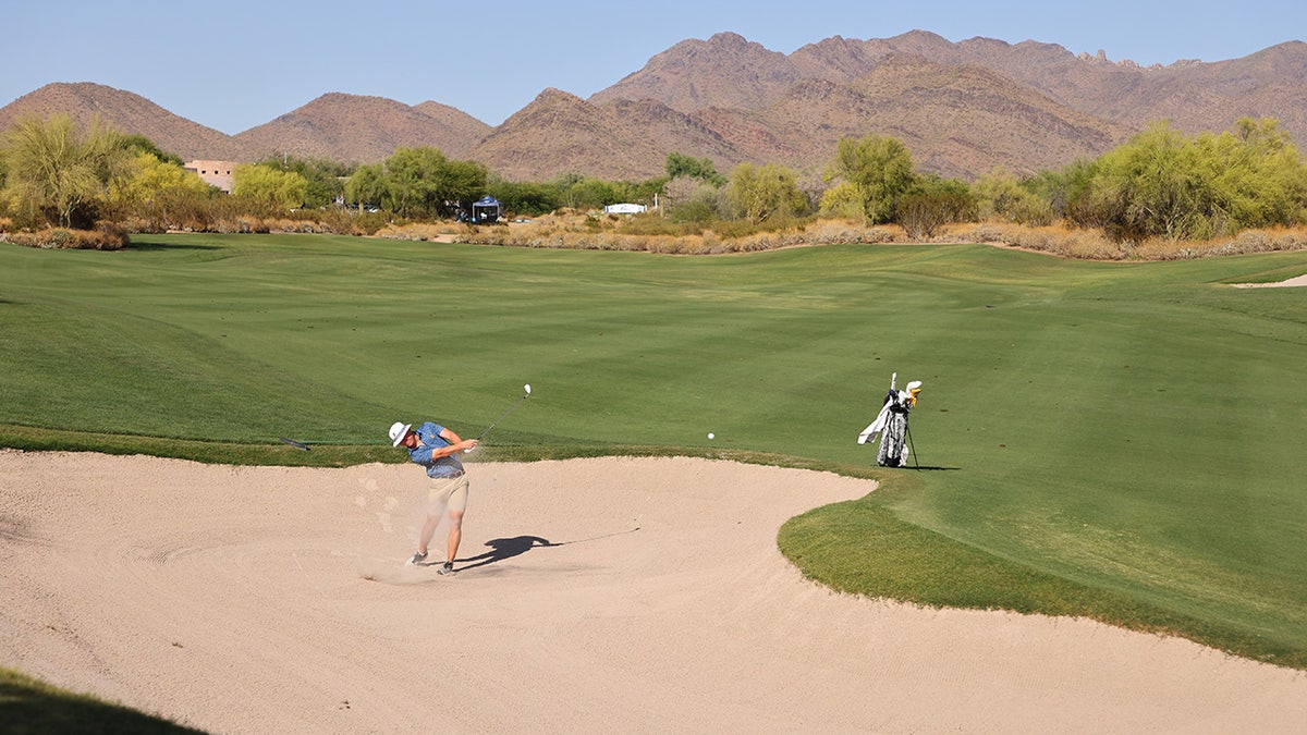 A member of the East Tennessee State Buccaneers pitches out of the sand during the Division I Men's Golf Championship held at Grayhawk Golf Club in Scottsdale, Arizona, on May 26, 2023.