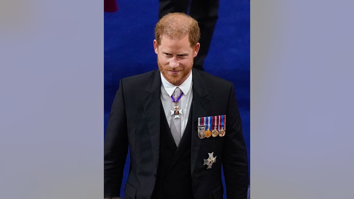 Prince Harry wearing a dark suit with medals