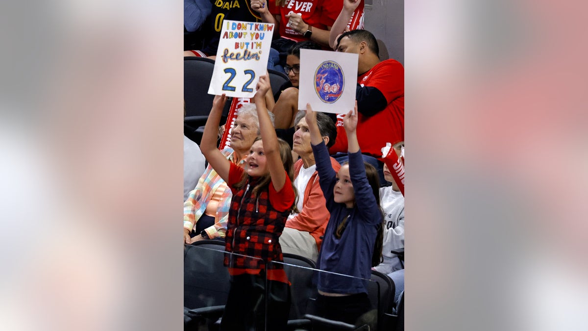 Fever fans hold up signs