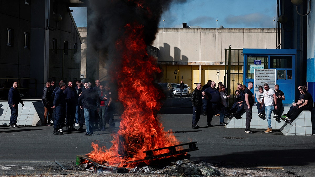 Fire burns outside detention center in France where fugitive Mohamed Amra escaped from prison
