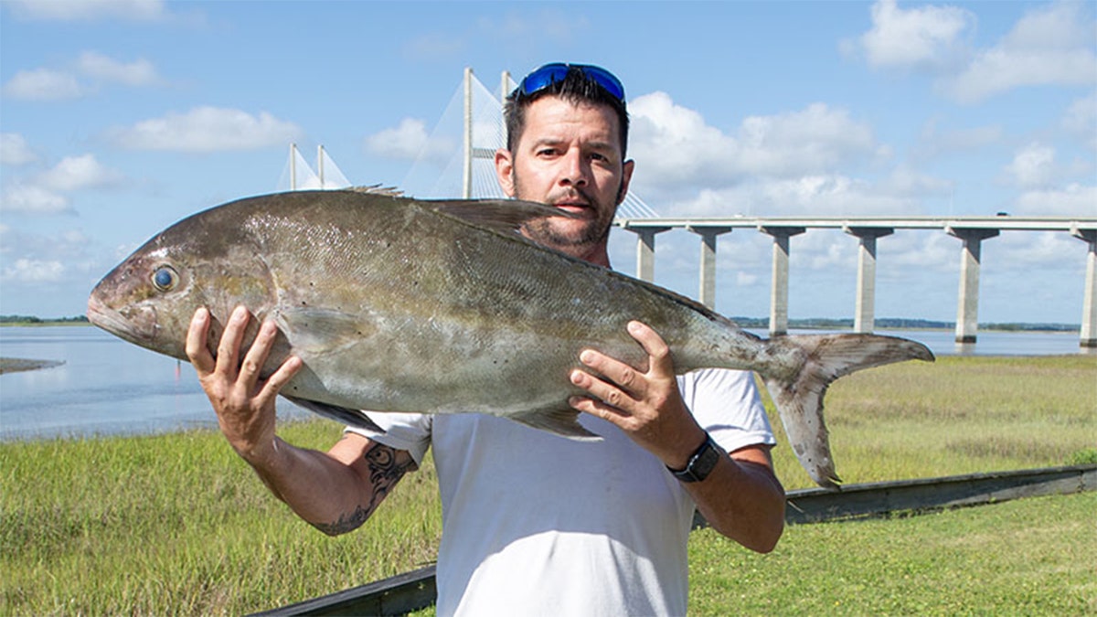 man holding fish