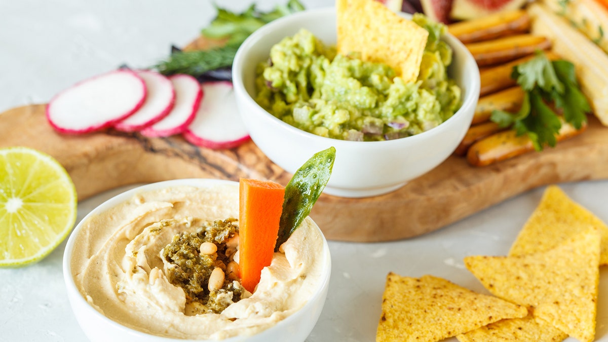 So, you love guacamole and hummus — but is it possible that one is better for you? Experts weigh in on the food debate.