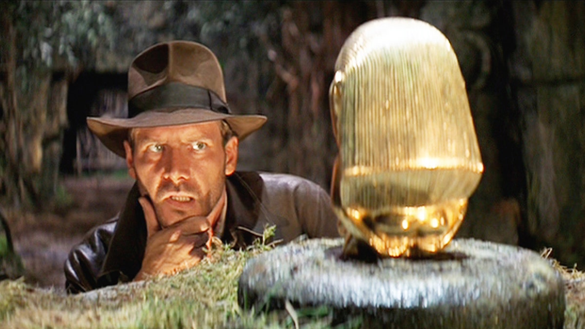 Harrison Ford as Indiana Jones looks at the idol in the first film