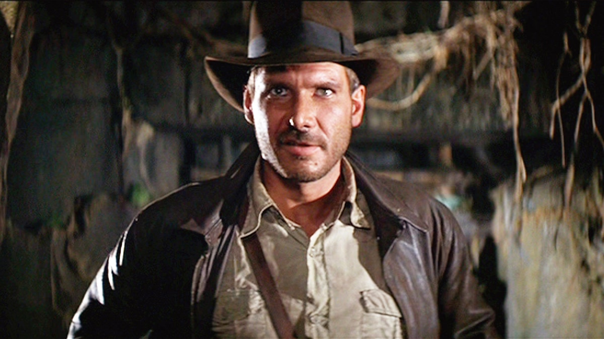 Harrison Ford in in a brown leather jacket and brown hat in "Indiana Jones"