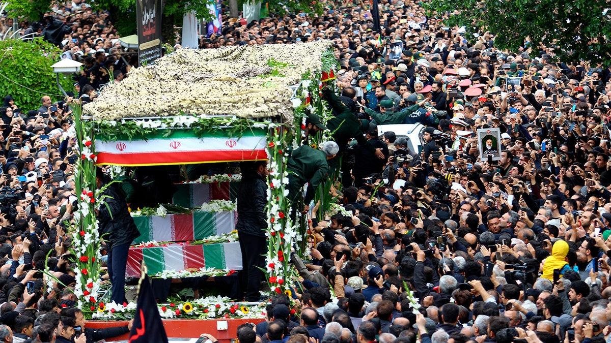 Mourners in Iran gather around procession for President Raisi