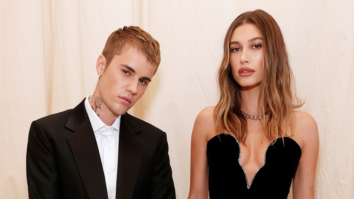 Justin Bieber poses next to wife Hailey Bieber on the red carpet