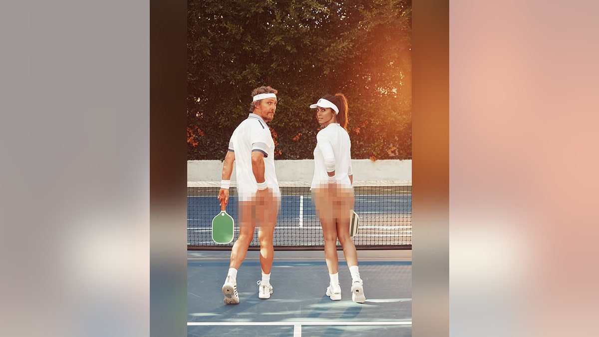 Matthew McConaughey and wife Camila in white tennis outfits look back at the camera on a pickleball court with their bums blurred and rackets
