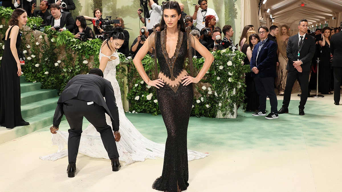 Kendall Jenner at the Met Gala 2024 red carpet in a black Givenchy Haute Couture sheer gown.