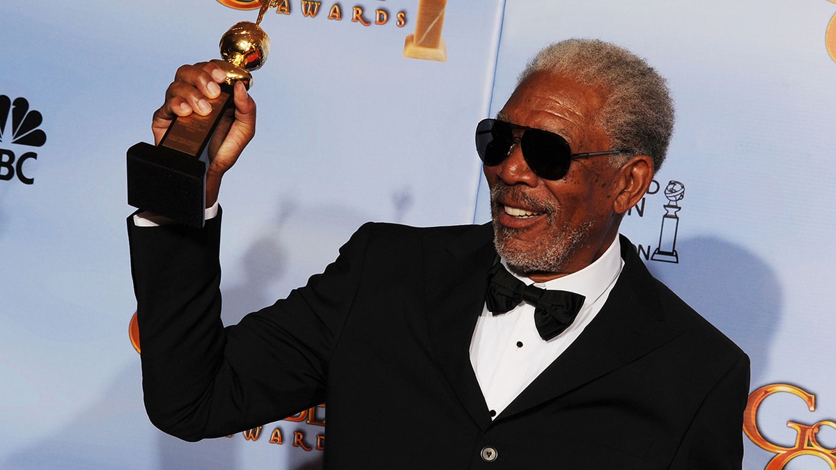 Morgan Freeman holding up Cecil B. DeMille award