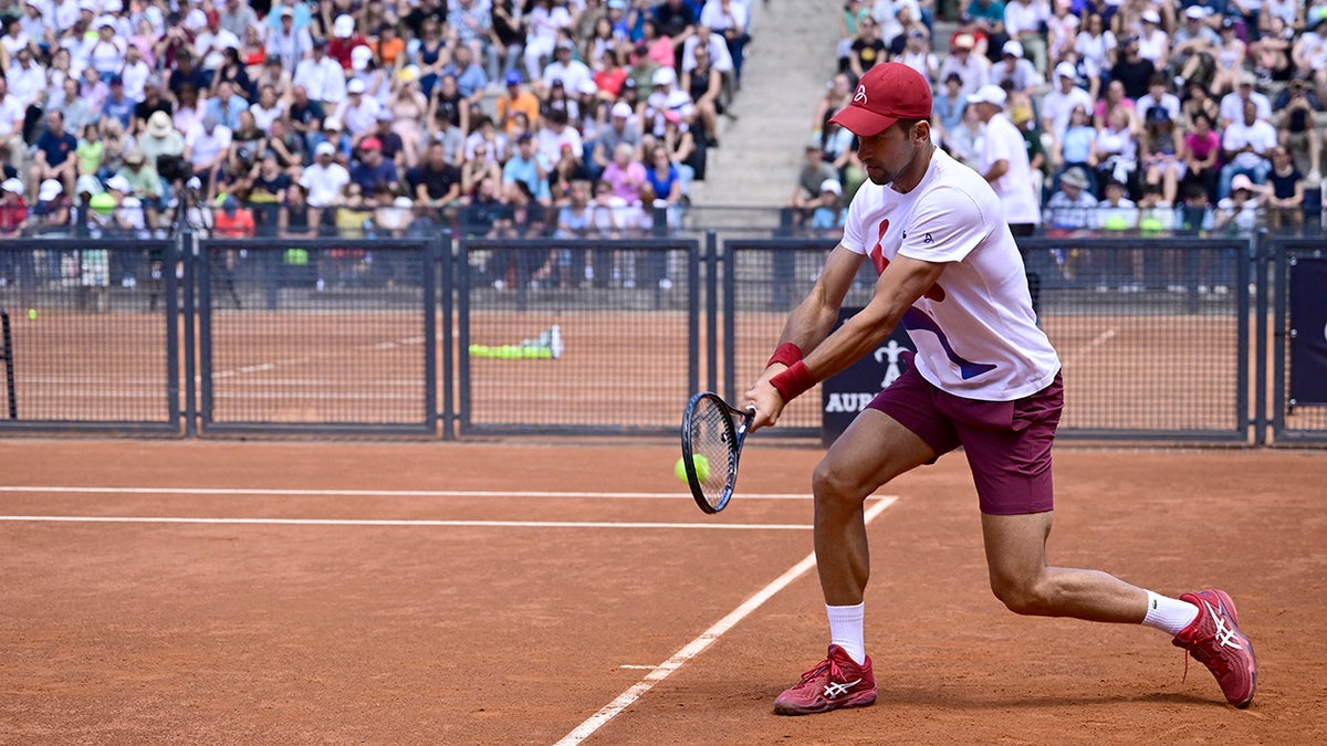 Novak Djokovic plays his backhand