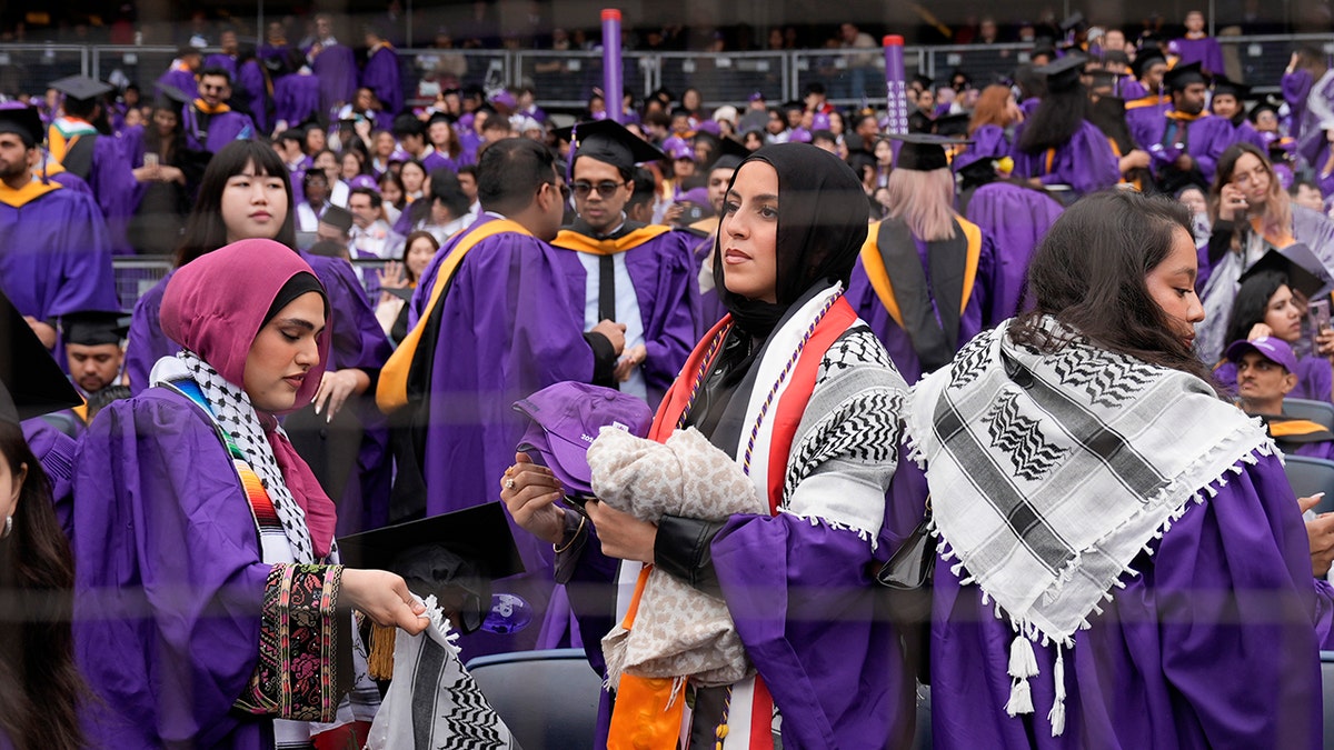 New York University graduates wearing keffiyahs leaving seats