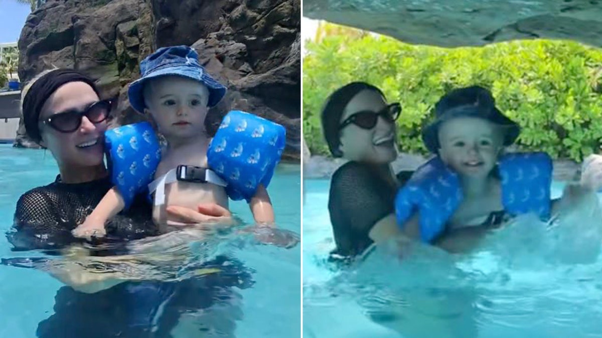 Paris Hilton holds onto her son Phoenix while they swim in a pool.