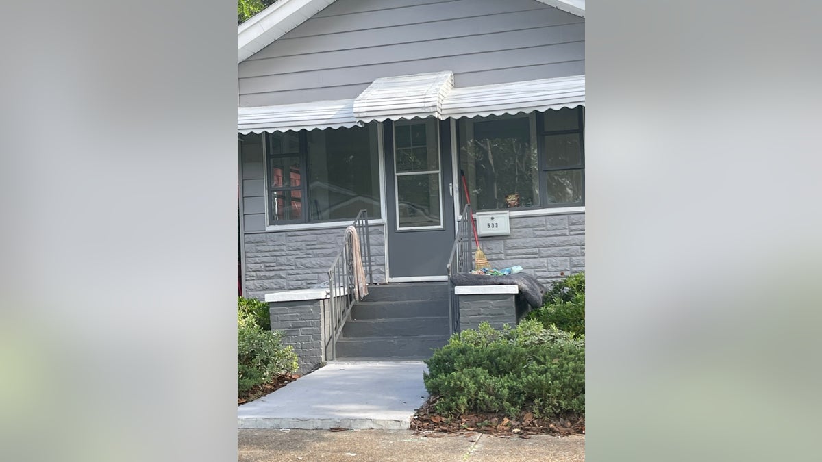 The outside of a Florida landlord's rental home after being taken over by squatters