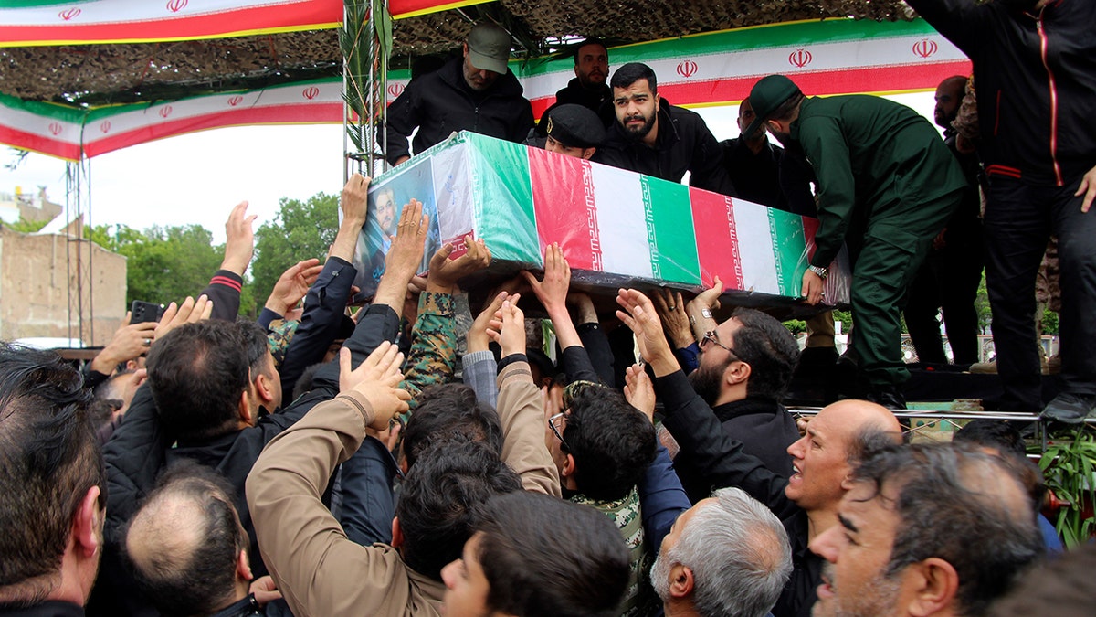 Mourners carry flag-draped coffin of Iranian Foreign Minister Hossein Amirabdollahian