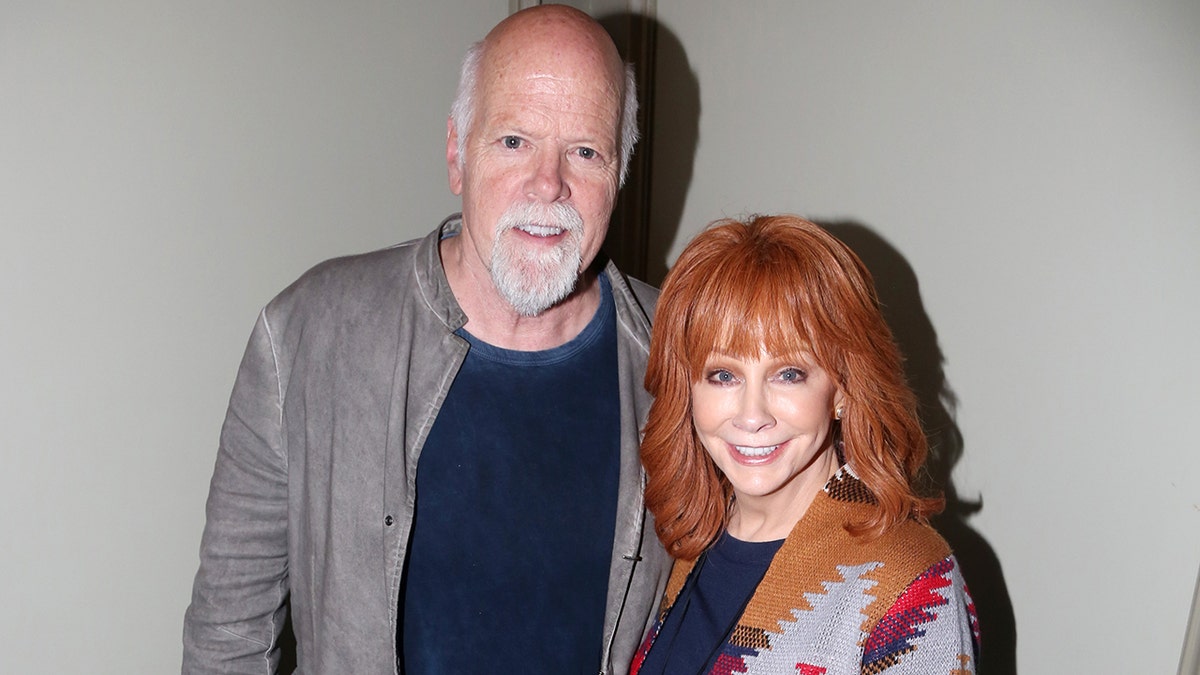 Reba McEntire and Rex Linn smiling for the camera