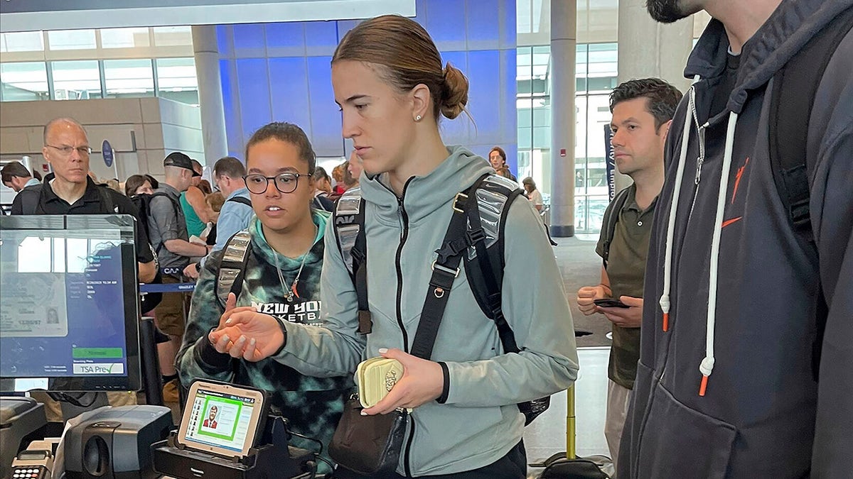 Sabrina Ionescu checks in with airport security