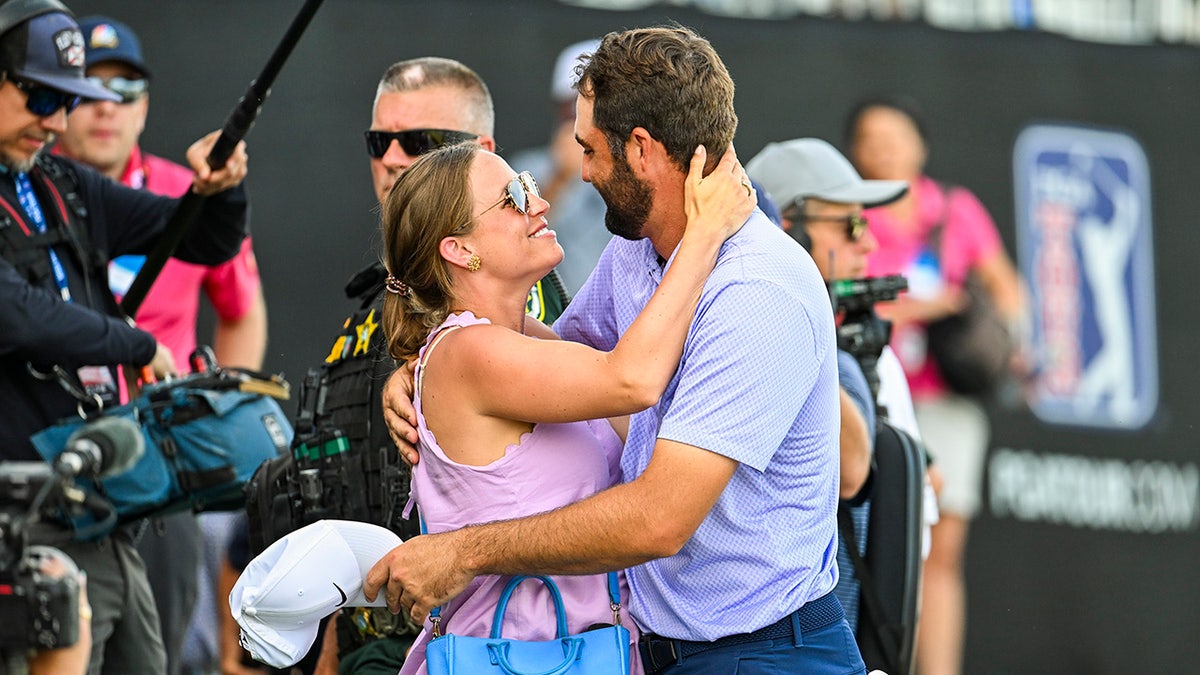 Scottie Scheffler and his wife celebrate at the Arnold Palmer Invitational