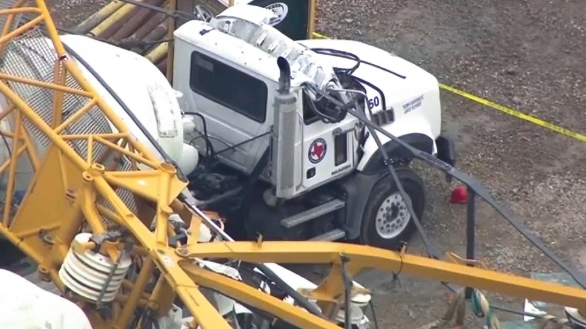 A crane falls and damages an industrial truck