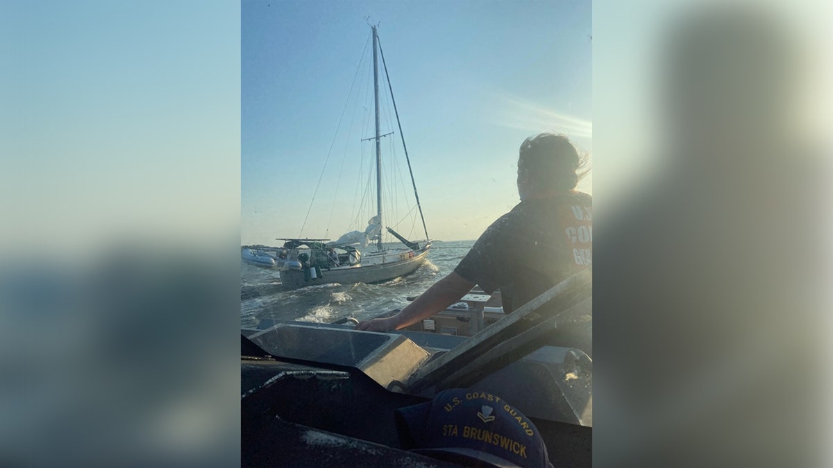 Coast Guard officials rescue a man whose sailboat ran aground off the coast of Georgia