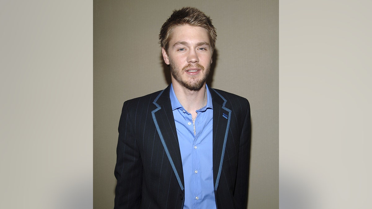 Chad Michael Murray in a black suit with blue trim and a blue shirt