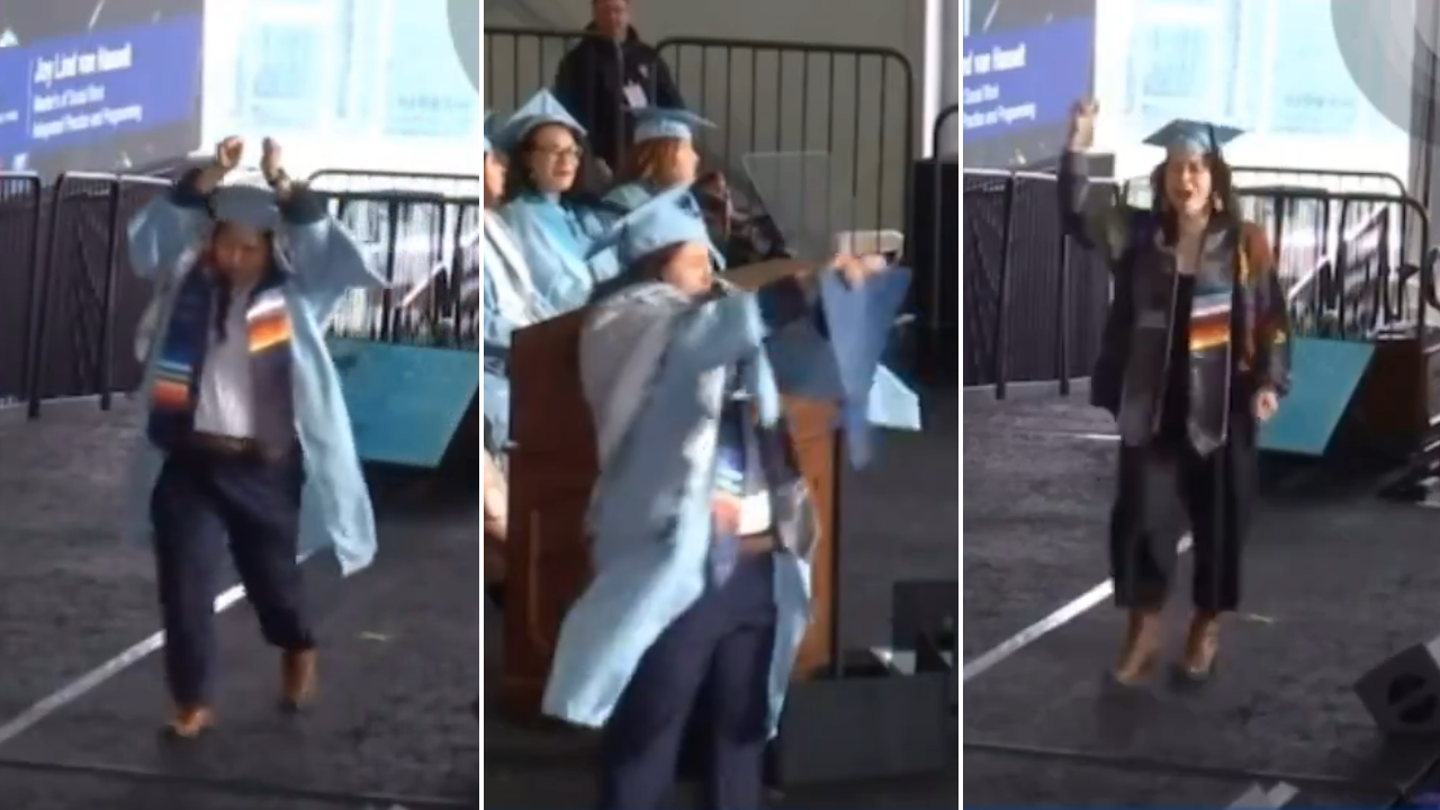 Columbia University student in handcuffs rips up diploma on commencement stage in act of protest