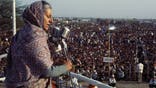Indira Gandhi speaks into microphone to crowd