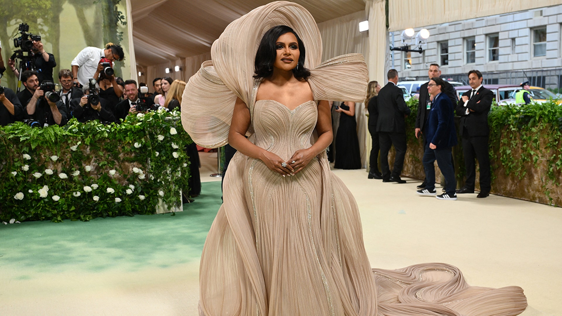 Mindy Kaling wears layers of silky to the Met Gala in New York.