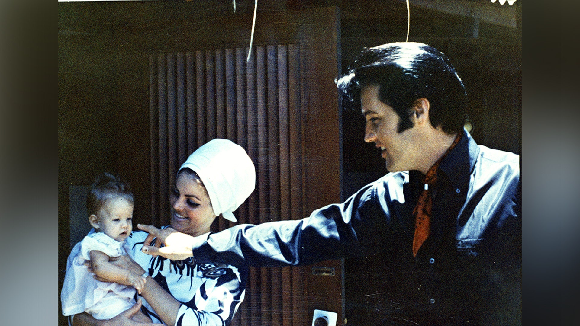 Elvis, Priscilla and Lisa Marie Presley enjoying time outside.