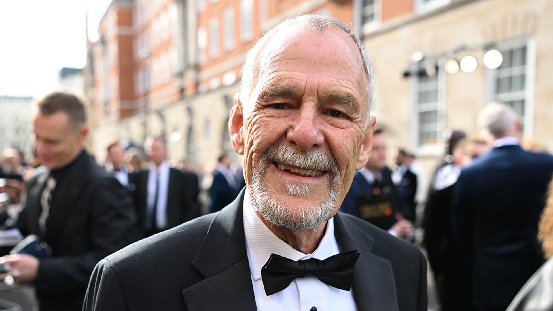 Actor Ian Gelder wears suit and bow tie to premiere.